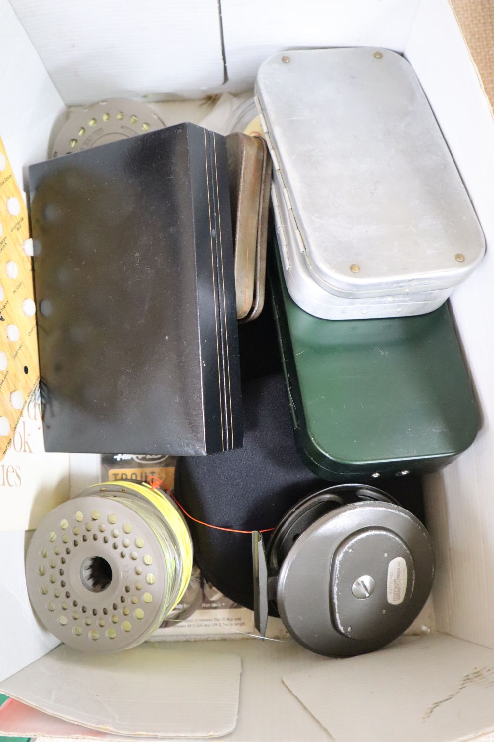 A collection of fishing flies and reels